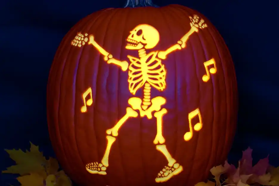 Pumpkin carved with a skeleton doing the dab dance pose.