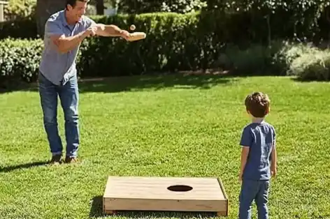 People playing cornhole on a grassy lawn