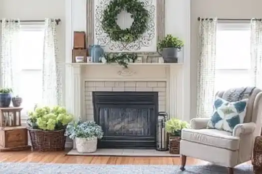 Cozy living room with a white fireplace, greenery, and an armchair.